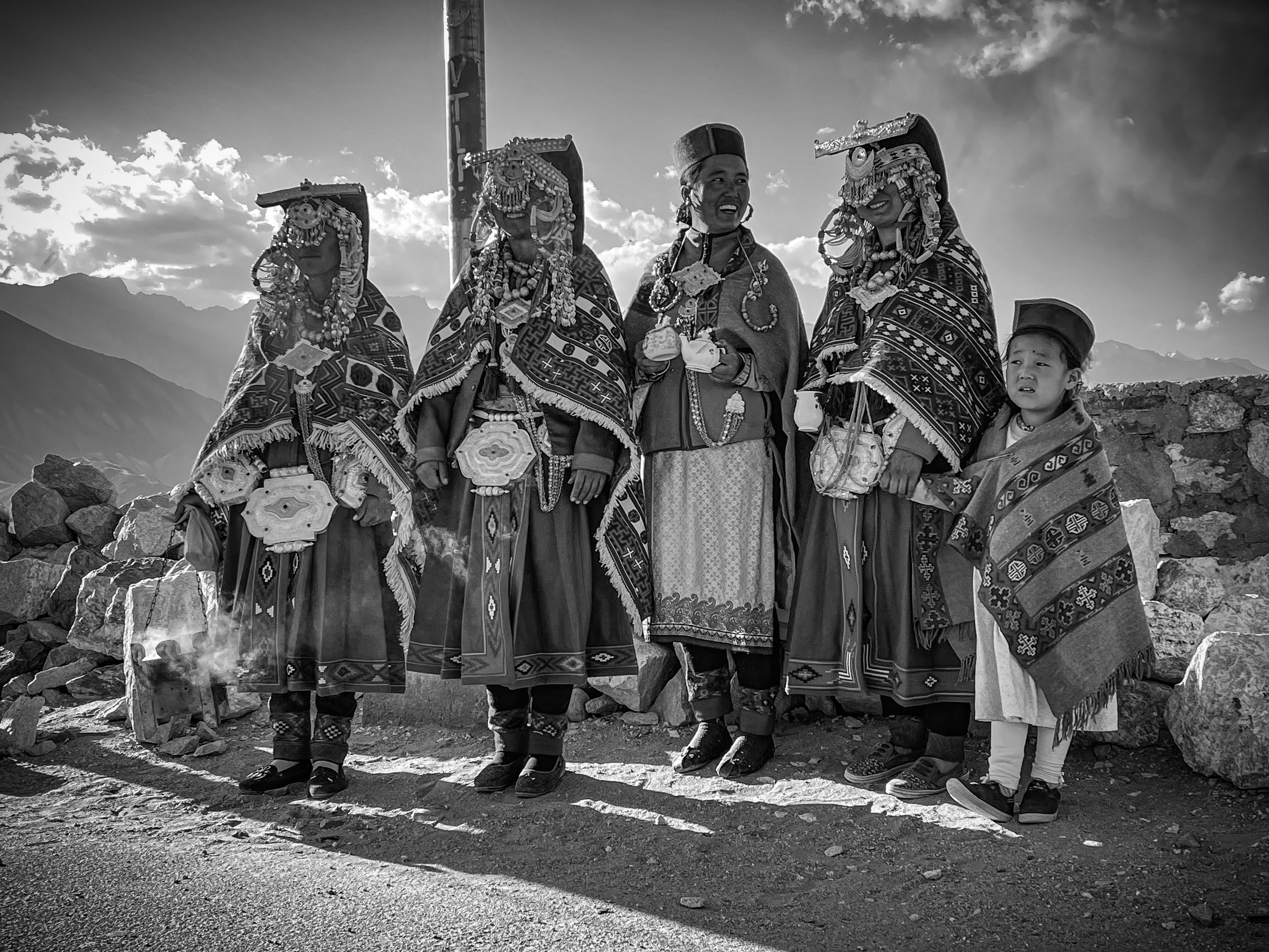 Women in traditional Kinnauri dress on mountain road