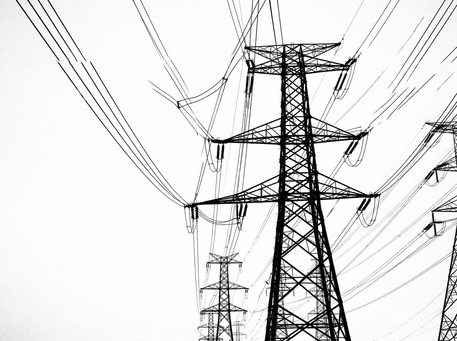 Power transmission towers and cables against empty sky