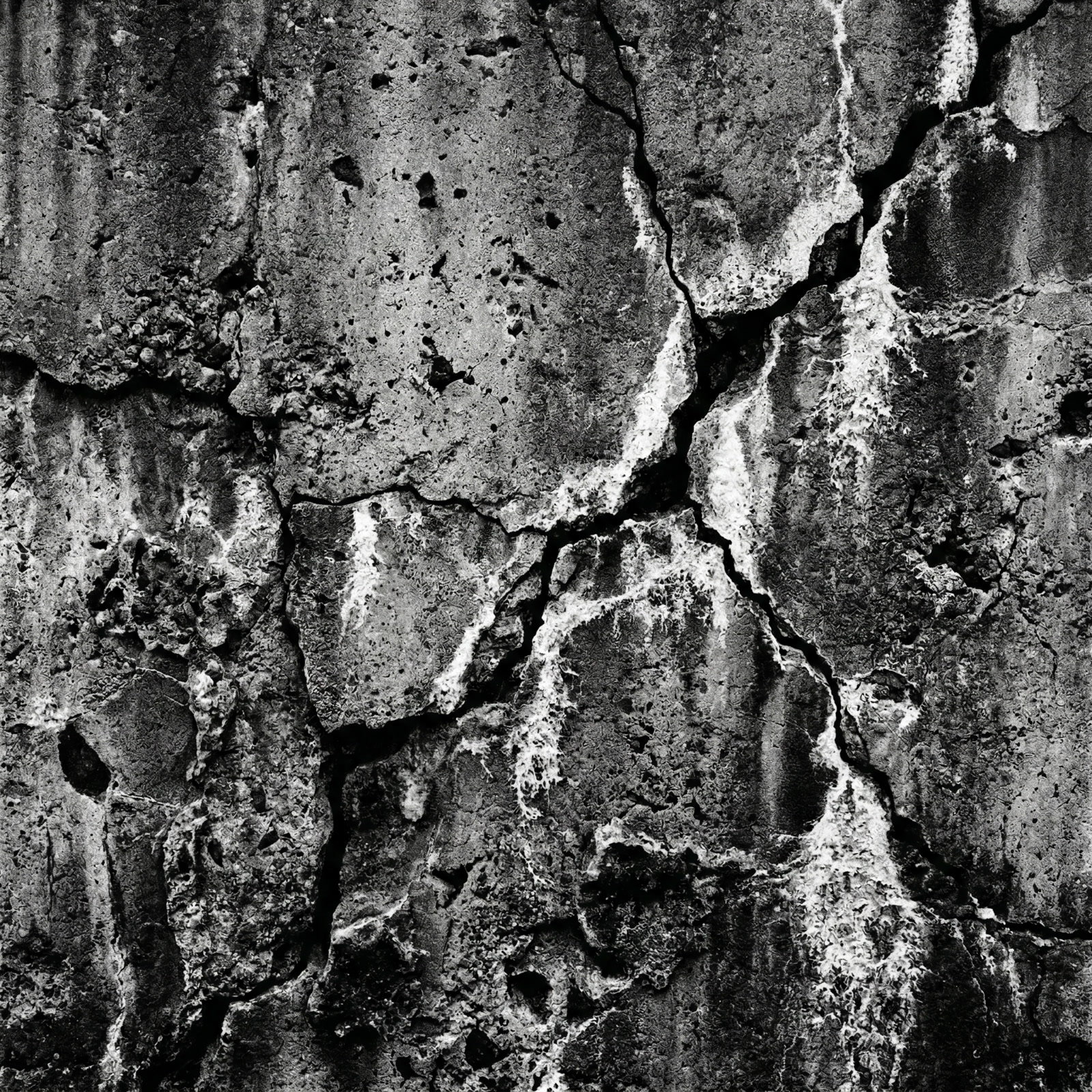 Weathered concrete wall texture with deep cracks